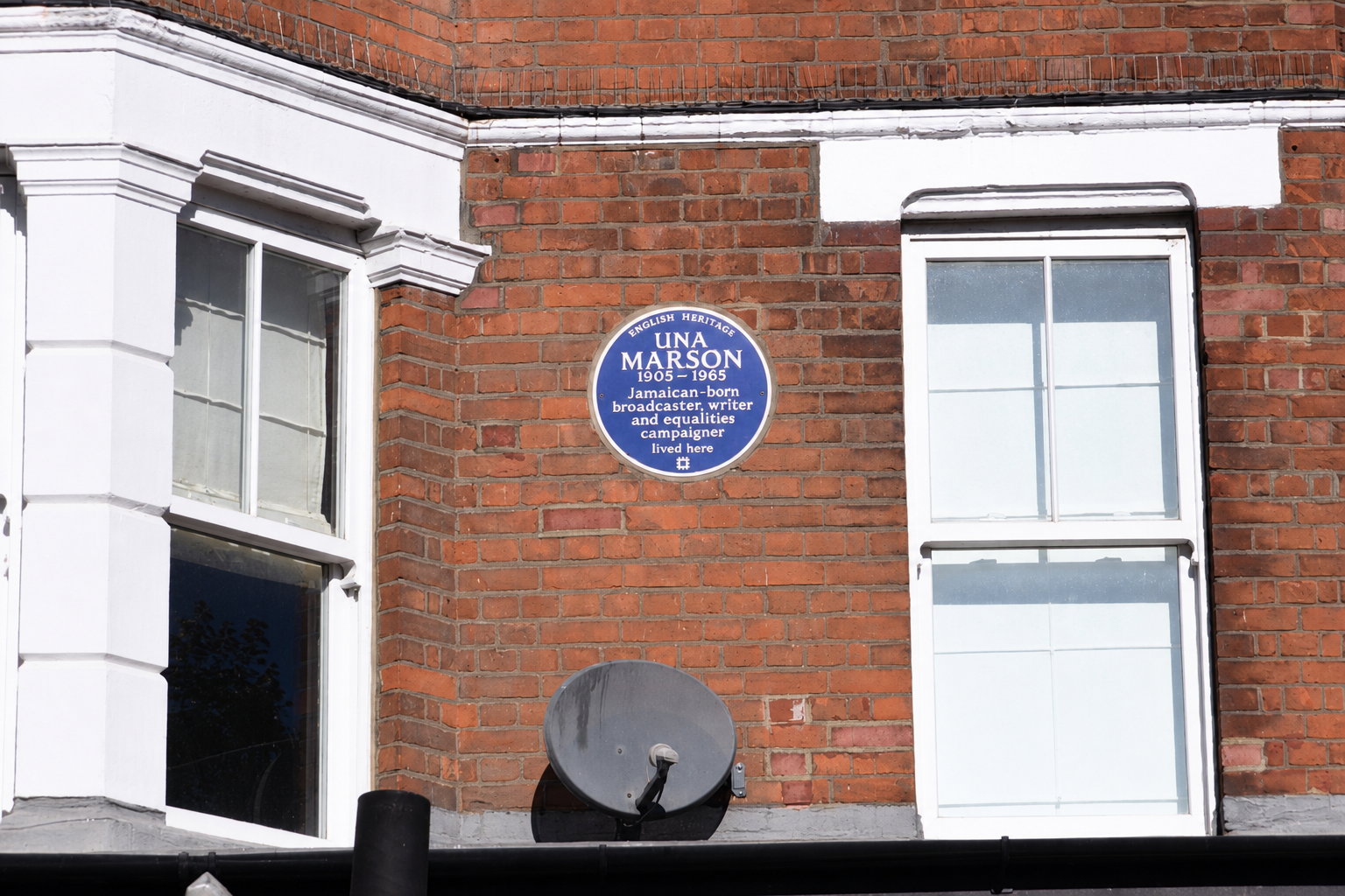 Blue English Heritage plaque commemorating Una Marson on Mill Lane, West Hampstead